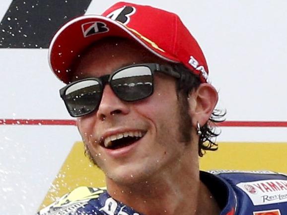 Yamaha MotoGP rider Valentino Rossi of Italy sprays champagne on the podium after placing third at the Malaysian Motorcycle Grand Prix at Sepang International Circuit near Kuala Lumpur, Malaysia, October 25, 2015. REUTERS/Olivia Harris