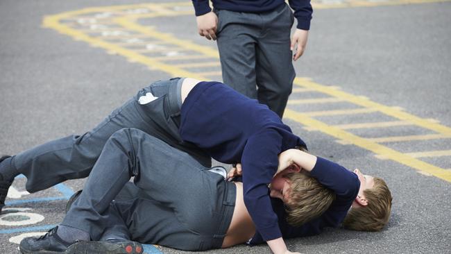 Two Boys Fighting In School Playground During Break Time