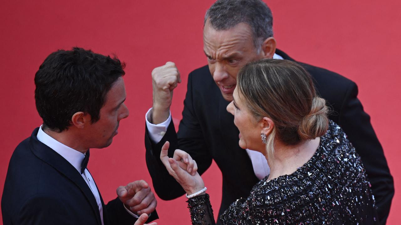 Tom Hanks and Rita Wilson speak with a staff member as they arrive for the screening of the film <i>Asteroid City</i> during the 76th edition of the Cannes Film Festival in France. (Photo by Antonin THUILLIER / AFP)