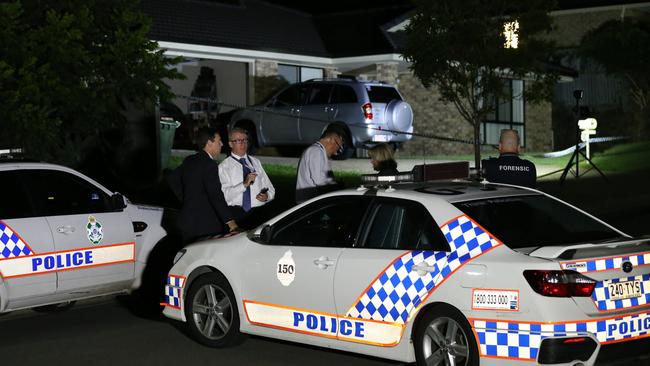 Police comb the area in front of an Upper Coomera house where two bodies were found. Picture Glenn Hampson