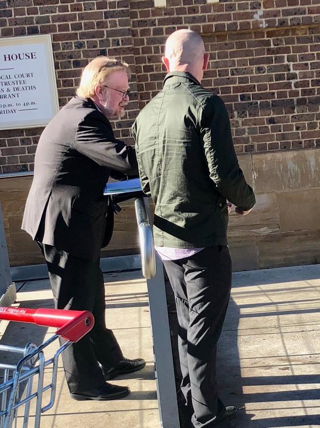 Spooner speaking to his legal representative outside Picton Local Court this morning.