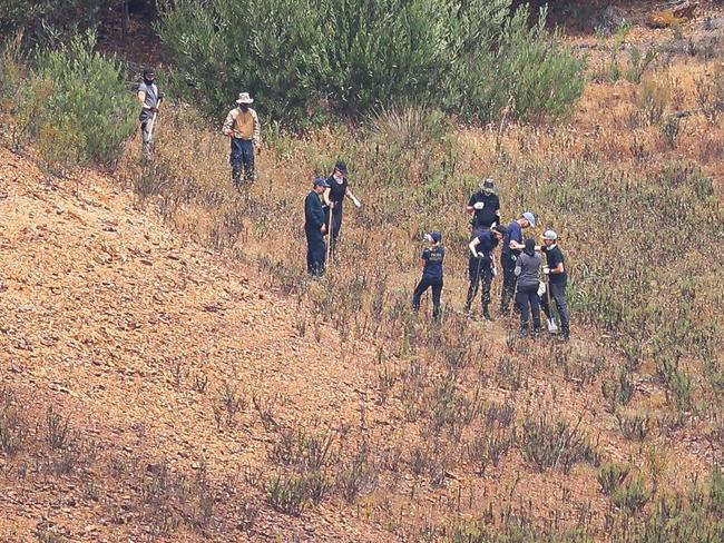 Police were seen digging with shovels before carrying away bags, thought it was unclear what they contained. Picture: AFP