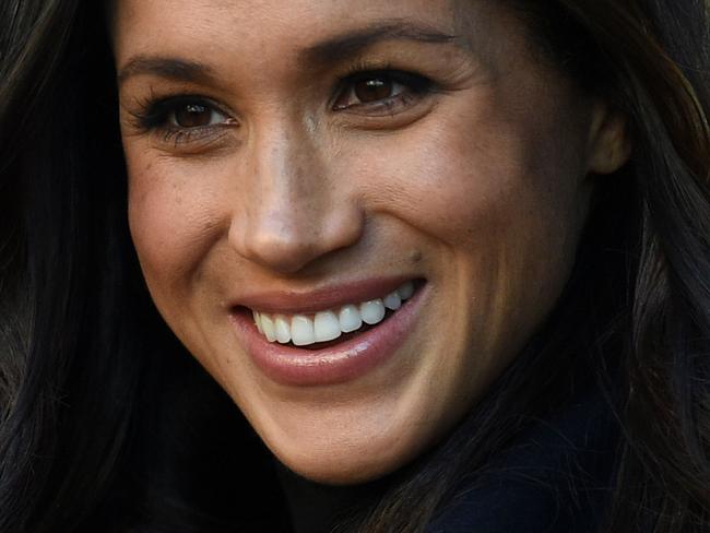 Britain's Prince Harry's fiancee US actress Meghan Markle greets wellwishers on a walkabout as they arrive for an engagement at Nottingham Contemporary in Nottingham, central England, on December 1, 2017 which is hosting a Terrence Higgins Trust World AIDS Day charity fair. Prince Harry and Meghan Markle visited Nottingham in their first set of engagements together since announcing their engagement. / AFP PHOTO / Oli SCARFF