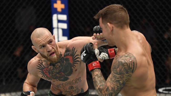 ABU DHABI, UNITED ARAB EMIRATES - JANUARY 23: In this handout image provided by the UFC, (L-R) Conor McGregor of Ireland punches Dustin Poirier in a lightweight fight during the UFC 257 event inside Etihad Arena on UFC Fight Island on January 23, 2021 in Abu Dhabi, United Arab Emirates. (Photo by Jeff Bottari/Zuffa LLC via Getty Images)