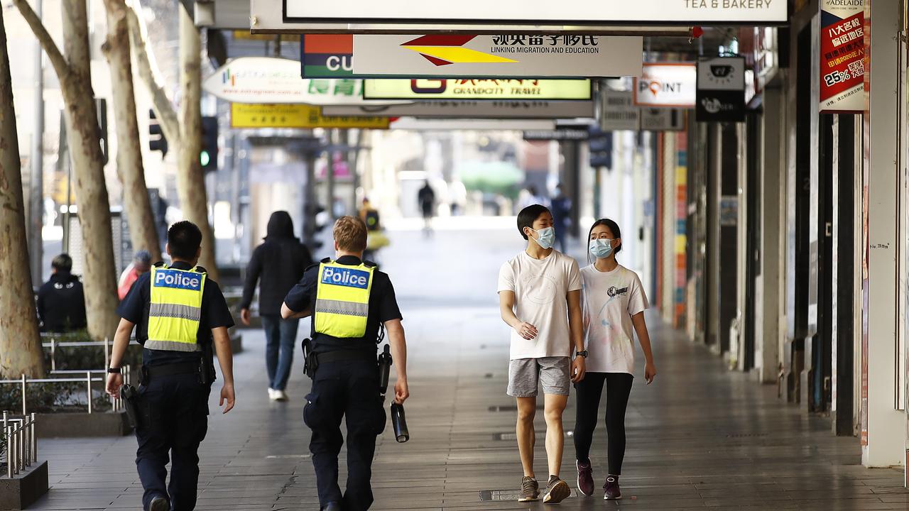 Police patrol along Elizabeth Street in Melbourne on Sunday. Picture: Daniel Pockett/Getty Images