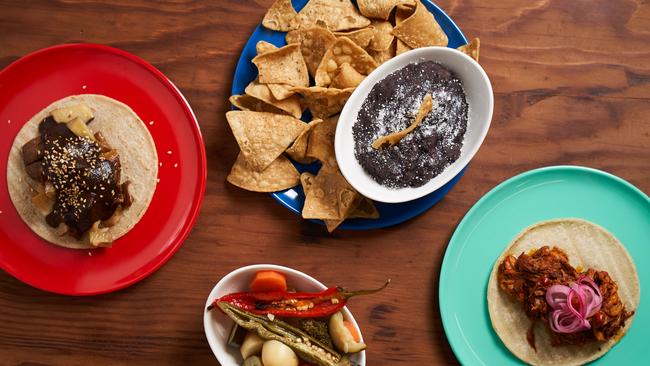 Vegan mole and pork tacos, with a side of frijoles and chiles en escabecha at La Popular Taqueria in Port Adelaide. Picture: Matt Loxton