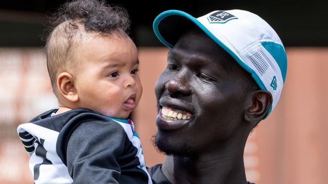 Aliir Aliir with his baby Mayom at Port Adelaide training. Source: Port Adelaide Instagram