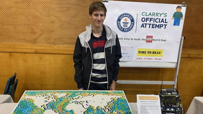 Clarry Farkash stands next to his completed LEGO world map after beating the previous Guinness World Record by two hours. Clarry completed the map in 7 hours, 9 minutes and 41 seconds. He has waited seven months for the final verdict after he lost a single piece and had to restart. Picture: (supplied)