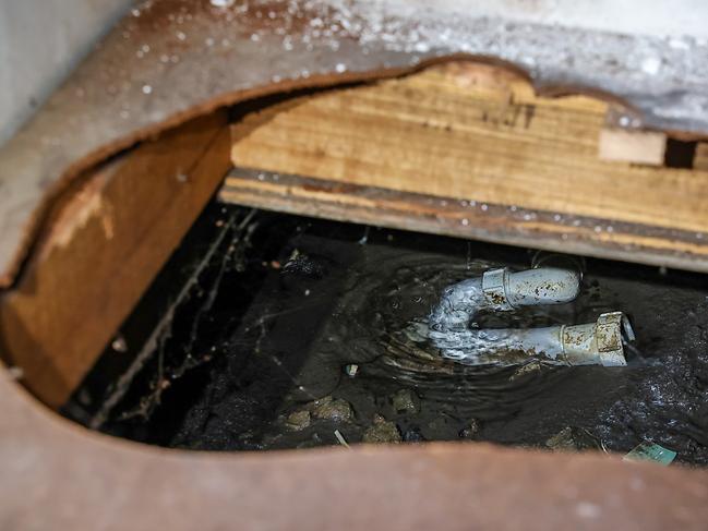 The leaking pipe under the hallway cupboard. Picture: Ian Currie