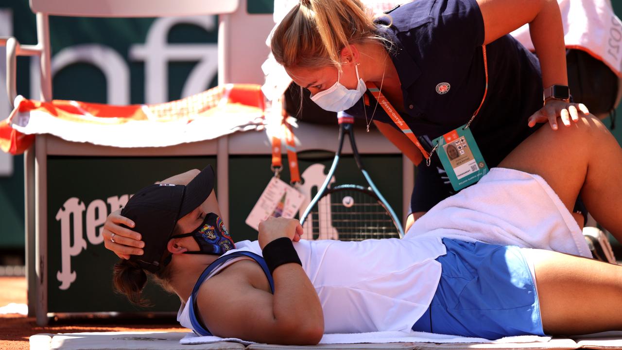 Ash Barty is given medical treatment. (Photo by Adam Pretty/Getty Images)