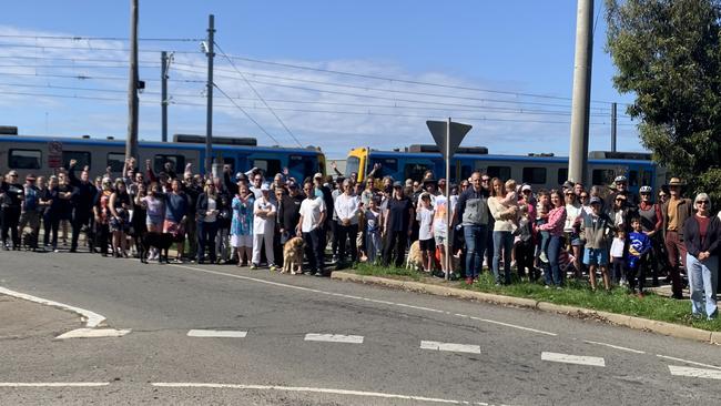 Hundreds of residents gather at the Champion Rd rail crossing in Newport to protest the state government's planned closing of the crossing.