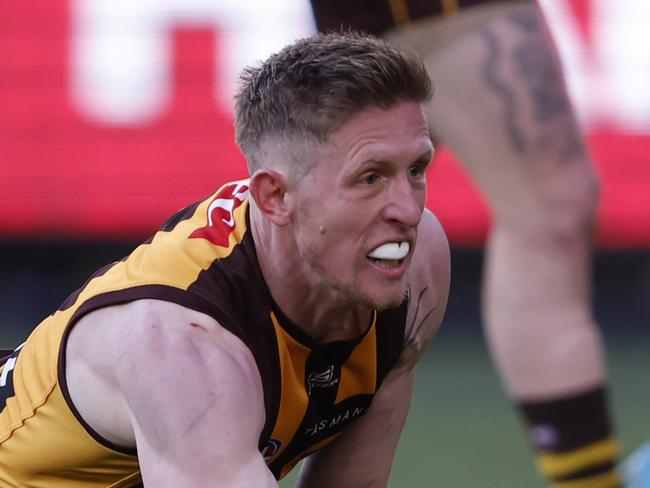 MELBOURNE, AUSTRALIA - AUGUST 18:  Sam Frost of the Hawks knocks the ball on during the round 23 AFL match between Hawthorn Hawks and Richmond Tigers at Melbourne Cricket Ground, on August 18, 2024, in Melbourne, Australia. (Photo by Darrian Traynor/Getty Images)