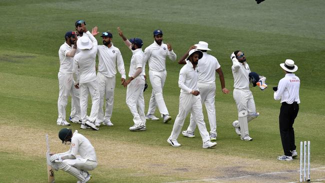 India players celebrate the win during day five of the first Test match between Australia and India at the Adelaide Oval in Adelaide, Monday, December 10, 2018. (AAP Image/Kelly Barnes) NO ARCHIVING, EDITORIAL USE ONLY, IMAGES TO BE USED FOR NEWS REPORTING PURPOSES ONLY, NO COMMERCIAL USE WHATSOEVER, NO USE IN BOOKS WITHOUT PRIOR WRITTEN CONSENT FROM AAP