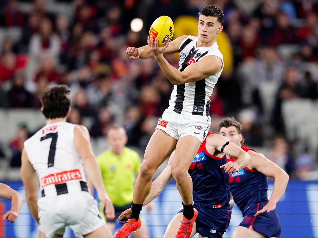 Nick Daicos handballs against the Demons. Picture: Dylan Burns/AFL Photos via Getty Images