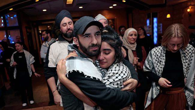 People hug at the Listen to Michigan watch party in Dearborn, Michigan, on Tuesday night. Picture: AFP