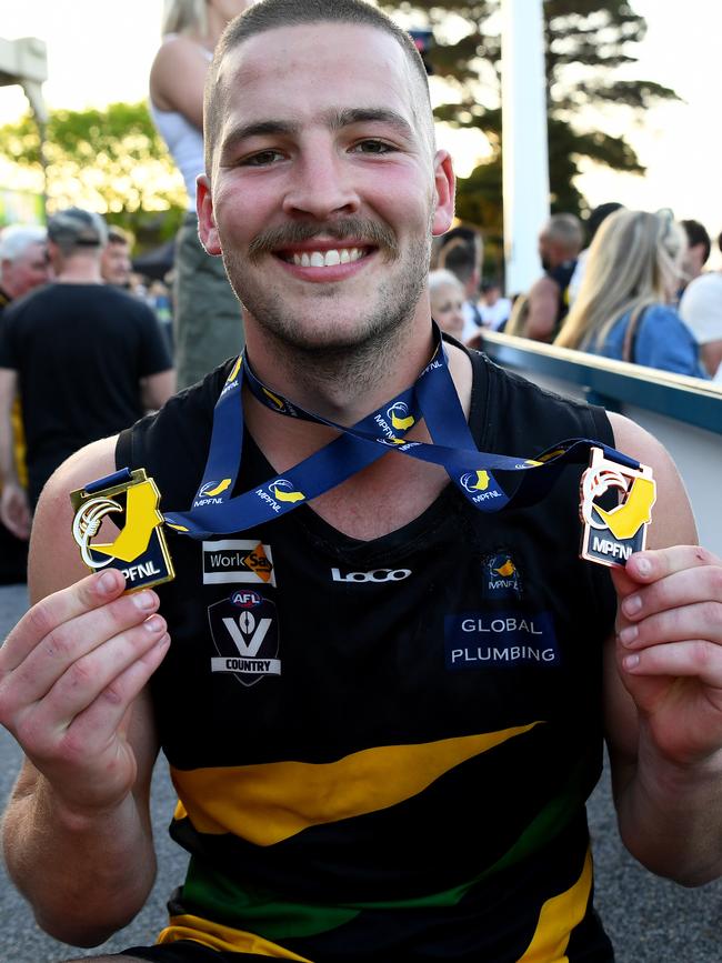 Billy Geurts of the Tigers poses with his premiership and best on ground medals. (Photo by Josh Chadwick)