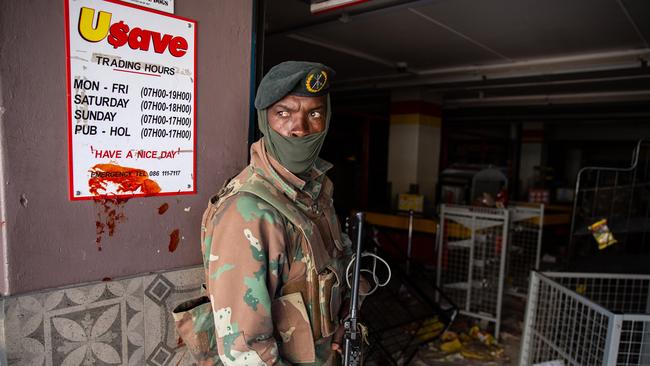 A South African soldier responds to looting at a shopping centre in Soweto. Picture: Getty Images.