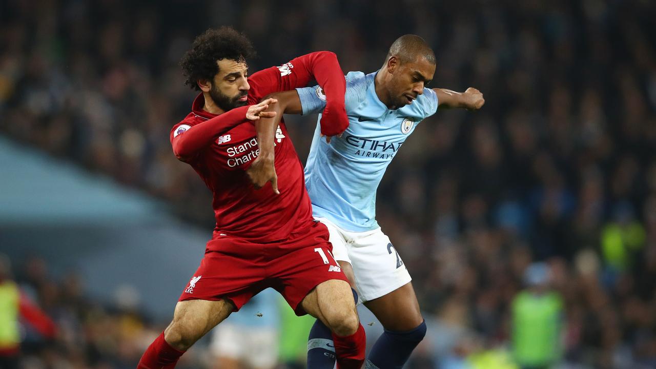 Mohamed Salah of Liverpool battles for possession with Fernandinho of Manchester City