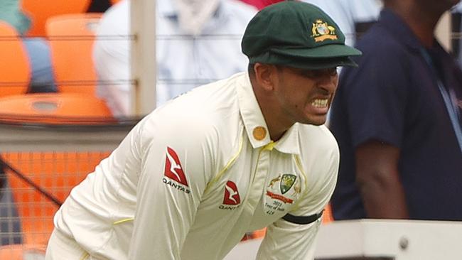 Usman Khawaja of Australia reacts after he was injured attempting to take a catch during day four of the Fourth Test match in the series between India and Australia at Narendra Modi Stadium on March 12, 2023 in Ahmedabad, India. (Photo by Robert Cianflone/Getty Images)