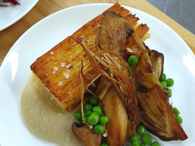 Potato and celeriac gratin with roast fennel, peas, mushrooms and onion sauce. Picture: Qantas