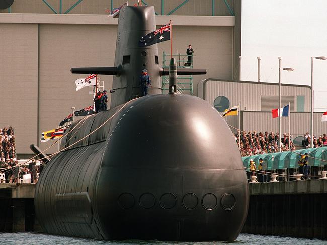 Needing change ... a Collins class conventional powered submarine being lowered into the water at Port Adelaide. Industry wants an open compeitition for the replacement contract. Picture: AFP