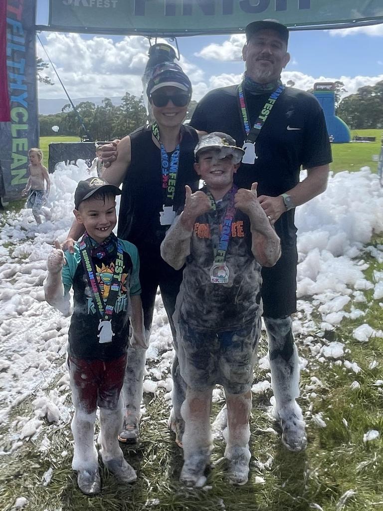 Nikki Ellison at the completion of FoamFest with her husband and sons Seb, 9, and Eli, 7.