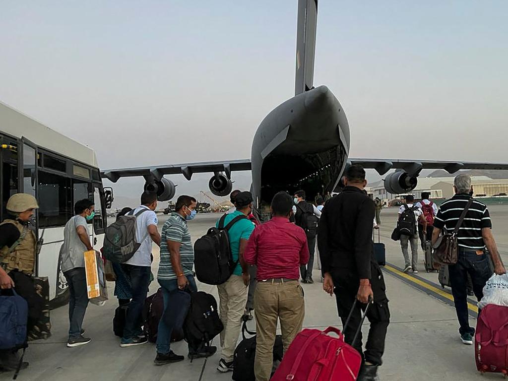 Indian Nationals prepare to board an Indian military aircraft at the airport in Kabul on August 17, 2021 to be evacuated after the Taliban stunning takeover of Afghanistan. Picture: AFP