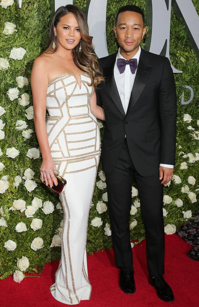 Chrissy Teigen and John Legend smoulder as they make their way into Radio City Music Hall.