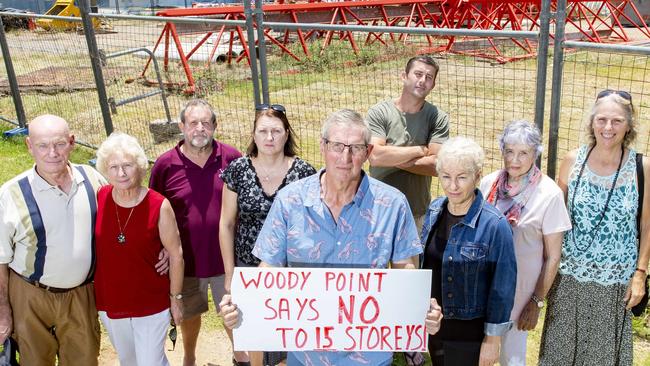 Derek Catterall and Woody Point Action Group members at the proposed site of the Traders in Purple development. PHOTO: AAP/Richard Walker