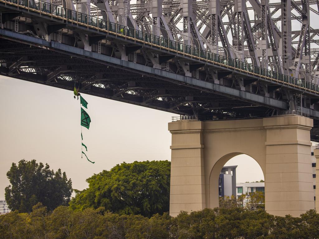 An activist from Extinction Rebellion dangles from the Story Bridge during Extinction Rebellion protests in Brisbane. Picture: Glenn Hunt/AAP