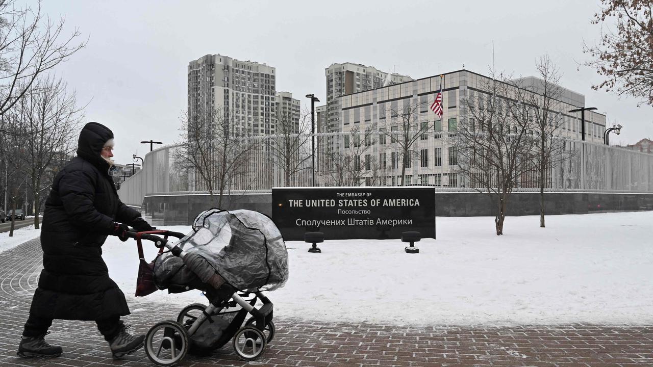 A woman pushes a pram past the US Embassy in Kiev. Picture: Sergei Supinsky / AFP