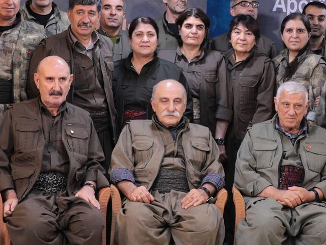 (Fron row from L) KCK (Kurdistan Communities Union) Executive Council member Sabri Ok and (Kurdistan Workers' Party) PKK Executive Committee members Duran Kalkan and Cemil Bayik pose with board members after they announced the party's dissolution during their 12th Party Congress at an undisclosed location in northern Iraq, on May 12, 2025. The Kurdistan Workers' Party (PKK) on May 12, 2025 announced its dissolution, saying it was ending its armed struggle against the Turkish state and drawing a line under its deadly four-decade insurgency. (Photo by ANF NEWS / AFP) / RESTRICTED TO EDITORIAL USE - MANDATORY CREDIT 
