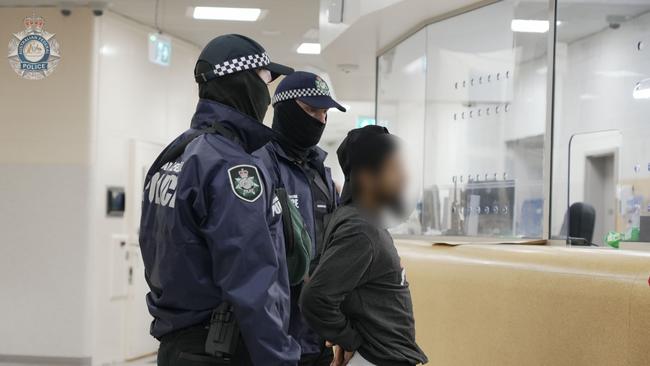 Accused terrorist recruiter Neil Prakash is escorted by police after arriving in Darwin from Turkey. Picture: AFP