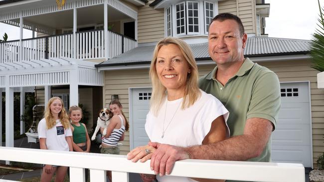 Troy and Sally McMillan with their kids Tayla, 15, Siena, 13, and Bella, 11, at their Kedron home they are selling. Picture: Liam Kidston