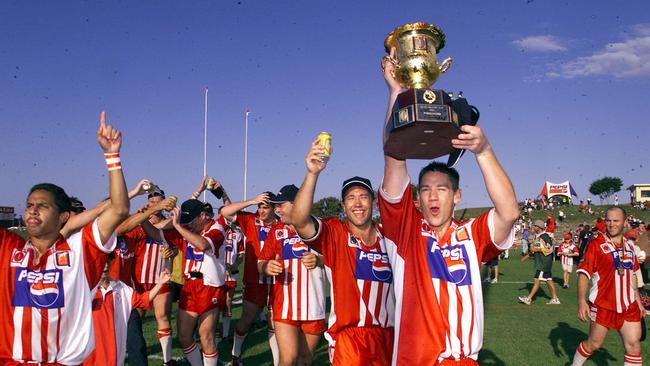 Redcliffe Dolphins lock Grant Flugge holds the premiership cup aloft.