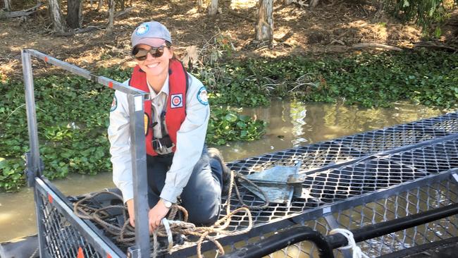 Wildlife Officer Kymberly Robinson atop a crocodile trap. Picture: Supplied