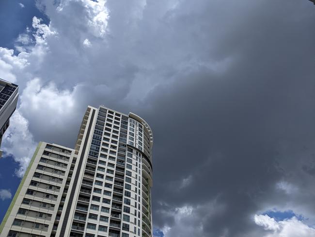 Dark clouds start to roll in over the Brisbane CBD on Saturday. Picture: David Clark