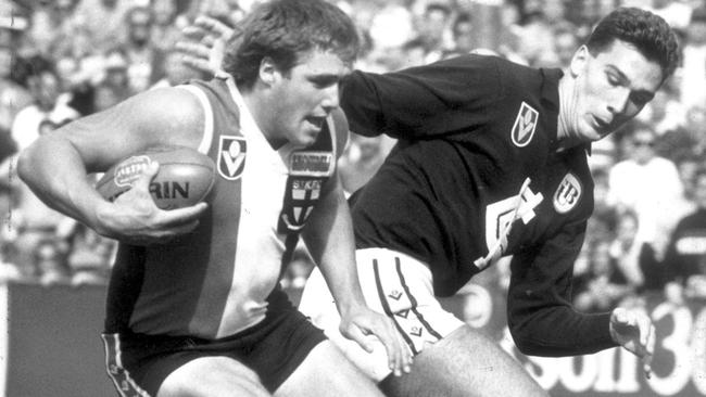 Tony Lockett breaks away from Stephen Silvagni in 1989.