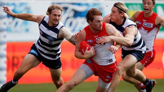 Tom Stewart and Mark Blicavs tackle Gary Rohan.