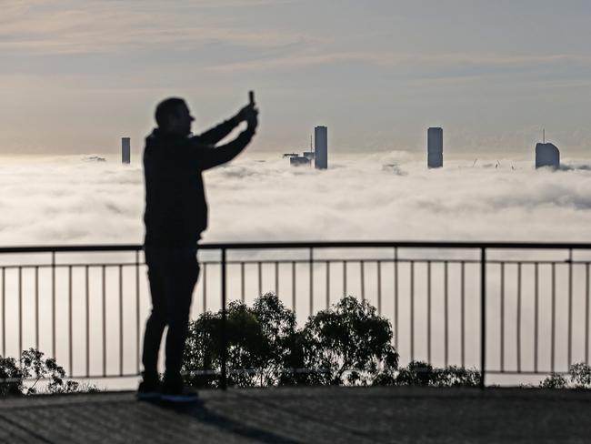 View of the Brisbane city covered in fog from the Mt Coot-Tha Summit Lookout.  Picture: Zak Simmonds