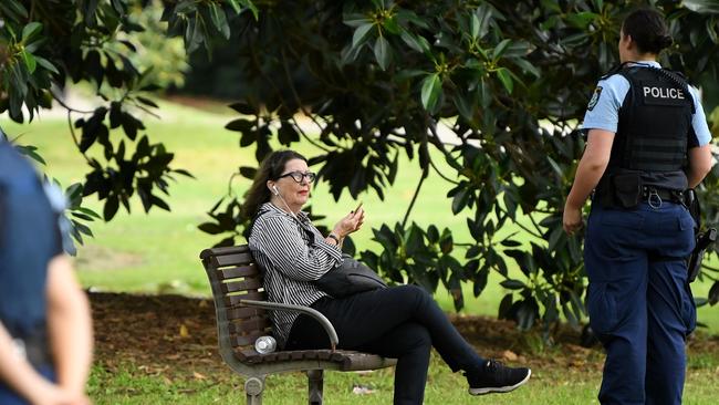 Police ask a woman to move on at Rushcutters Bay park. Picture: AAP Image/Joel Carrett