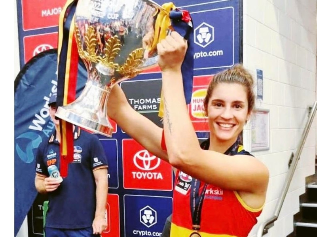 Former St Mary’s and PINT footballer Jasmyn Hewett with the 2022 AFLW premiership cup. Picture: Adelaide Crows.