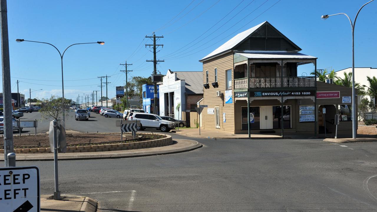 THEN AND NOW: The 2013 flood devastated businesses throughout Bundaberg including Envious Hair on the corner of Targo and Woondooma streets. Photo: Max Fleet / NewsMail