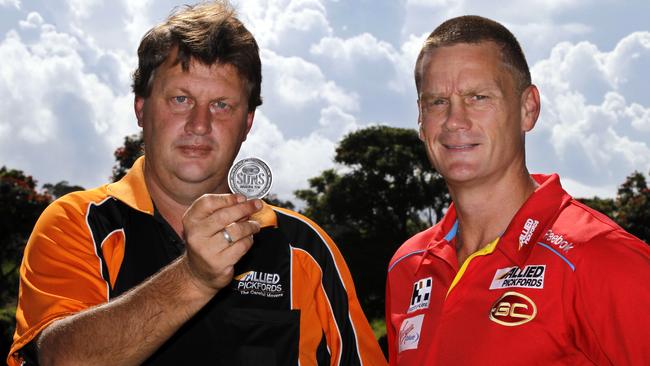 Gold Coast Suns coach Guy McKenna and Paul Fowles with a replica of the coin tossed in the Suns’ first game.