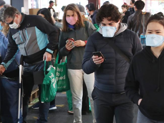 Shoppers at Melbourne’s Queen Victoria Market on Sunday, adhering to mask requirements.