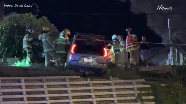 Car left hanging from carpark wall