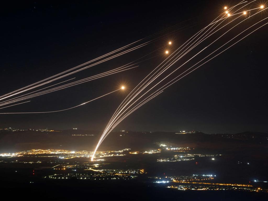 Rockets fired from southern Lebanon are intercepted by Israel's Iron Dome air defence system over the Upper Galilee region in northern Israel, last week. Picture: AFP