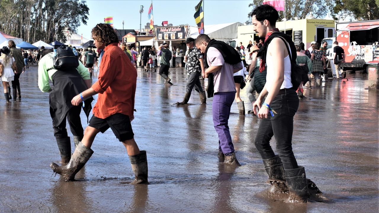 Attendees waded through mud at the festival on Sunday. Picture: Tessa Flemming