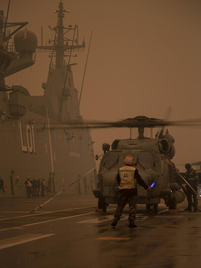 A Royal Australian Navy MH-60R Seahawk 'Romeo' Helicopter refuels on-board HMAS Adelaide during Operation Bushfire Assist 2020. Picture: ADF/Supplied