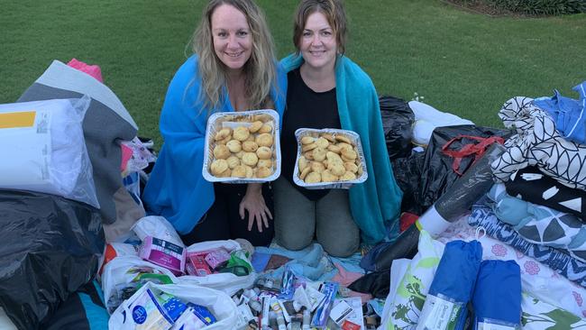 Sisters Cathy and Shelley Gelling show off the huge pile of blankets, toiletries, tents and homemade biscuits which were donated by friends and family to be distributed to the homeless. 